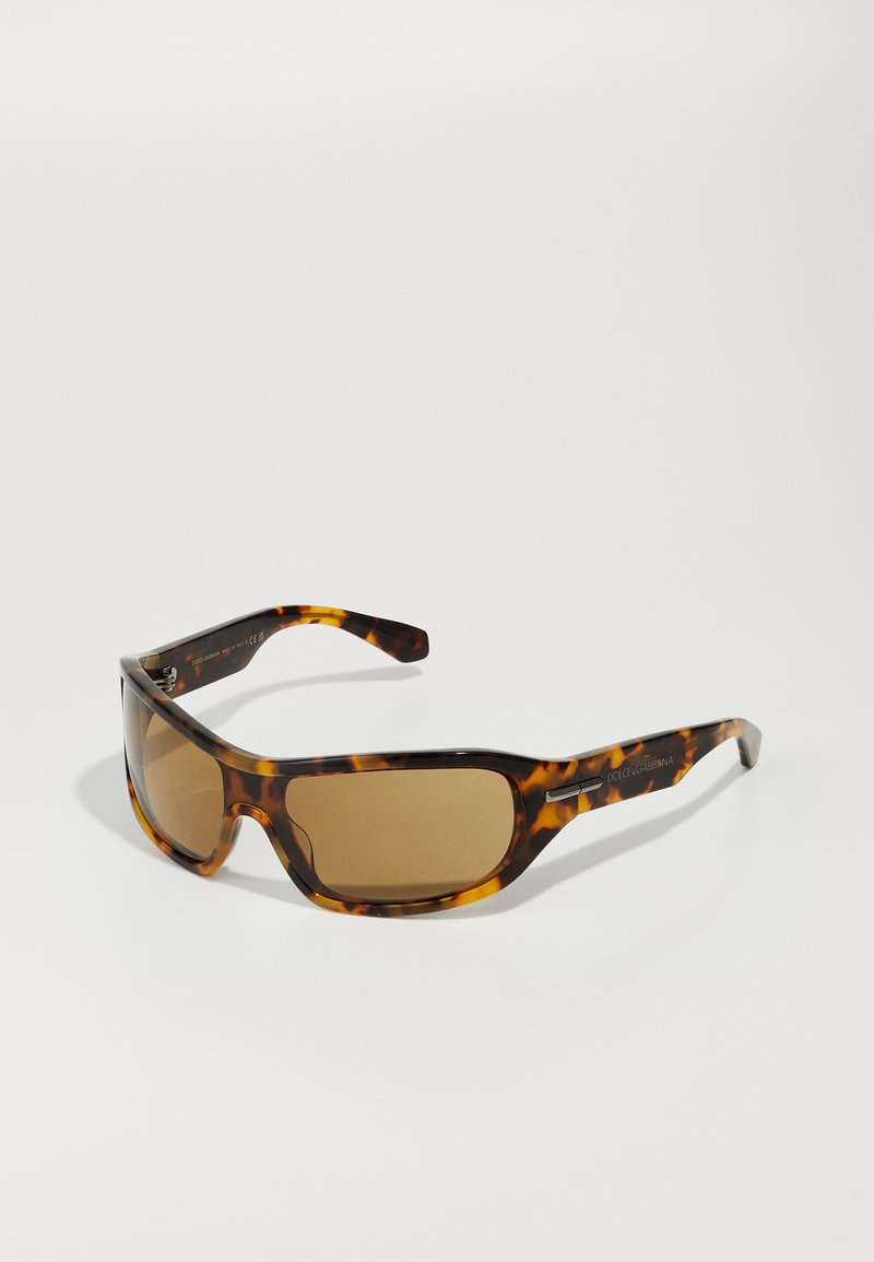 Tortoiseshell sunglasses with brown lenses, a thick frame, and sleek arms featuring silver accents. Textured finish adds a distinctive look.