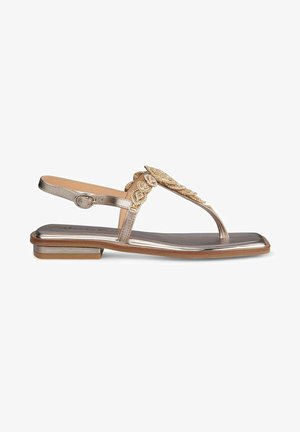 Metallic gold sandal with a T-strap design, embellished with intricate detailing, a low block heel, and a cushioned footbed.
