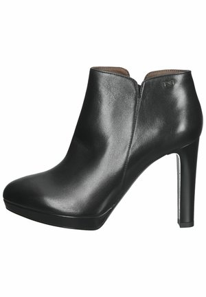 Black leather ankle boots with a smooth texture, high heel, rounded toe, and a subtle cutout design at the ankle.