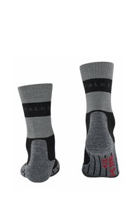 Calze grigie e nere con texture a coste. Presentano un band con logo e suola imbottita, con talloni e punte rinforzati. Parte superiore a maglia piatta.
