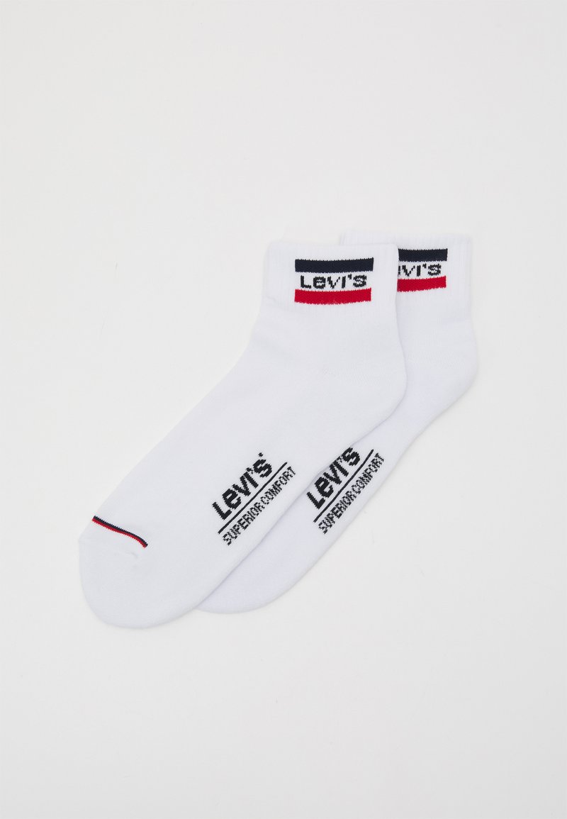 Fehér pamutzokni fekete és piros Levi's logóval. A szöveg tartalmazza a „Levi's” és a „Kitűnő Kényelem” feliratokat. Bokáig érő, sima tapintású.