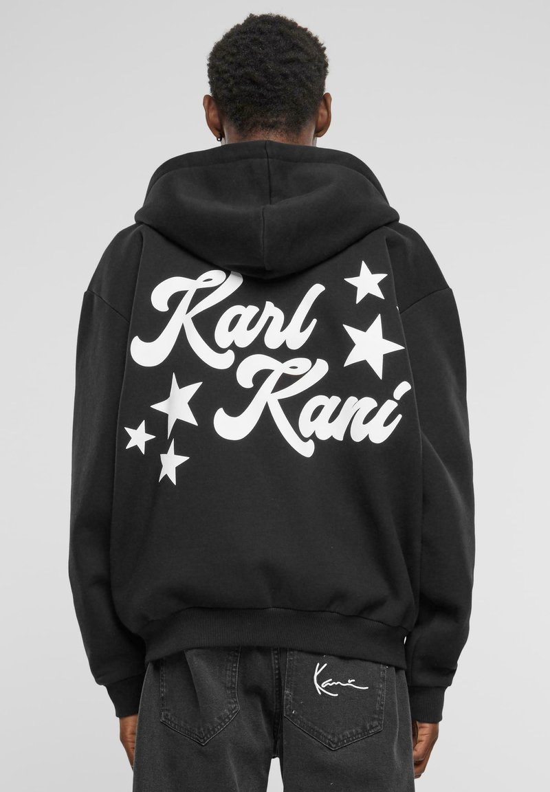 Black hoodie with white “Karl Kani” text and star graphics on the back. Features a large hood and ribbed cuffs and hem.