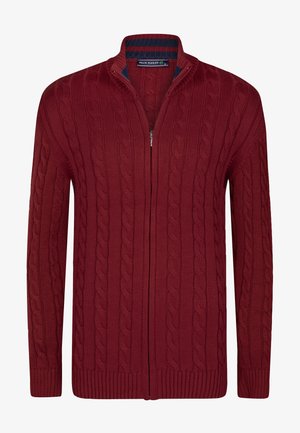 Punane nööriga kardigan kõrge krae, täispikk zipper, soonilised varrukasuu ja ääred. Valmistatud tekstuurist, sooja materjalist.