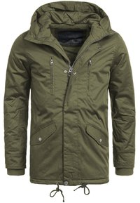 Oliwkowa parka z kapturem, na zamek błyskawiczny i zatrzaski, z dwoma kieszeniami na piersi i dwiema kieszeniami bocznymi. Rękawy z ribbingu i sznurkiem w dolnej części.
