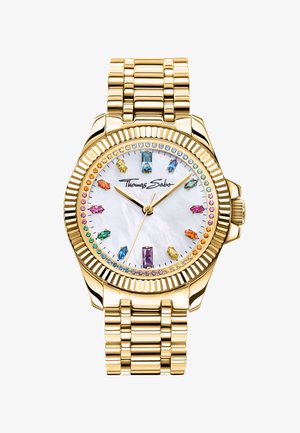 Montre-bracelet en or avec cadran blanc, index des heures en pierres précieuses multicolores, lunette en pierres arc-en-ciel et logo "Thomas Sabo" au centre.