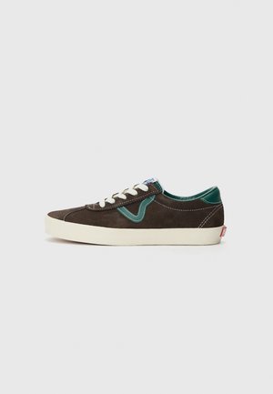 Brown suede sneakers with a green accent, round toe, white laces, and a cream rubber outsole. Features contrasting stitching and logo tag.