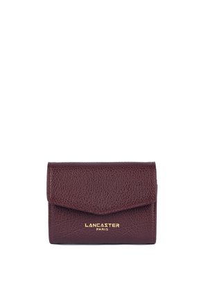 Small dark brown leather wallet with flap closure and gold "Lancaster Paris" logo centered on the front.