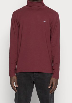 Maglione a collo alto bordeaux a maniche lunghe realizzato in tessuto morbido; presenta un piccolo logo bianco sul petto e un design dal taglio rilassato.