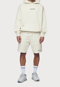 Pegador Jersey con capucha - beige