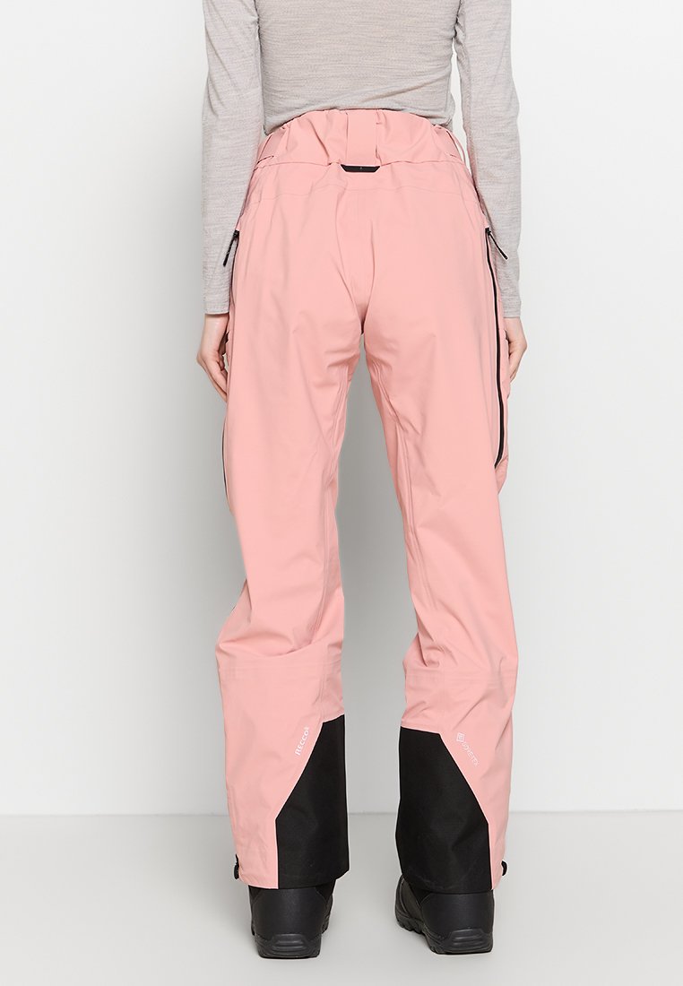 Rosa wasserdichte Skihose mit schwarzen unteren Bündchen, ausgestattet mit seitlichen Reißverschlusstaschen und einem hohen Bund für eine verstellbare Passform.
