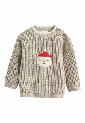 Beżowy sweter dziergany z motywem twarzy Świętego Mikołaja w białym i czerwonym kolorze, okrągły dekolt oraz guziki na jednym ramieniu.