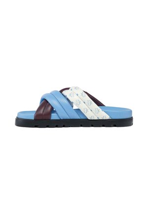 Slide sandal with black sole and quilted crossed straps in blue, maroon, and white with blue patterned logos on the white strap.