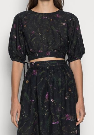 Sort cropped top med pufferm, blomsterprint i lilla og grøn, tekstureret stof. Parret med en matchende nederdel med bundet detaljer.