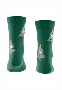 Grüne Socken mit Weihnachtsbaum-Designs, versehen mit Schneemännern, Ornamenten und Sternen. Hergestellt aus weichem Material mit einem gerippten Bündchen.