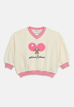 Sweat crème avec col, poignets et ceinture à rayures roses, avec des raquettes de ping-pong roses croisées et le texte "Mini Rodini".
