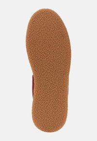 Brown, textured rubber sole with a fuzzy finish; features a stamped size "42" near the heel; no visible patterns or accents.