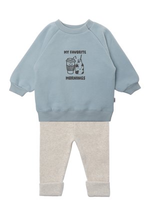 Light blue long-sleeve sweatshirt with "My Favorite Mornings" text and coffee and milk bottle graphics, paired with light beige pants.