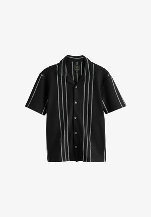 Black short-sleeve shirt with vertical white stripes, button-up design, and a collar; textured fabric with a ribbed finish.