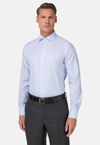 Lichtblauw geruit overhemd met een puntkraag, lange mouwen en een knoopsluiting, gecombineerd met donkergrijze broek en een zwarte riem.