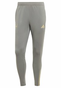 Pantalones deportivos grises fabricados con tejido suave, con un logo de Arsenal dorado y acentos dorados en las piernas inferiores. Ajuste elástico con cintura elástica.