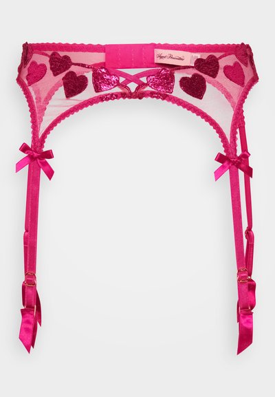 Rosa blonde strømpebånd med hjerteformede paljetter, bølgede kanter og satengsløyfer på stropper. Har justerbare stropper og krokfeste.