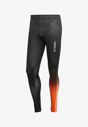Schwarze Sportleggings mit strukturiertem Muster, einem verlaufenden orangen Streifen und drei weißen Streifen entlang des unteren Beins. Logo an der Seite.