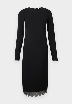 Robe midi noire à manches longues avec encolure ronde et ourlet festonné, ornée de détails délicats de broderie.