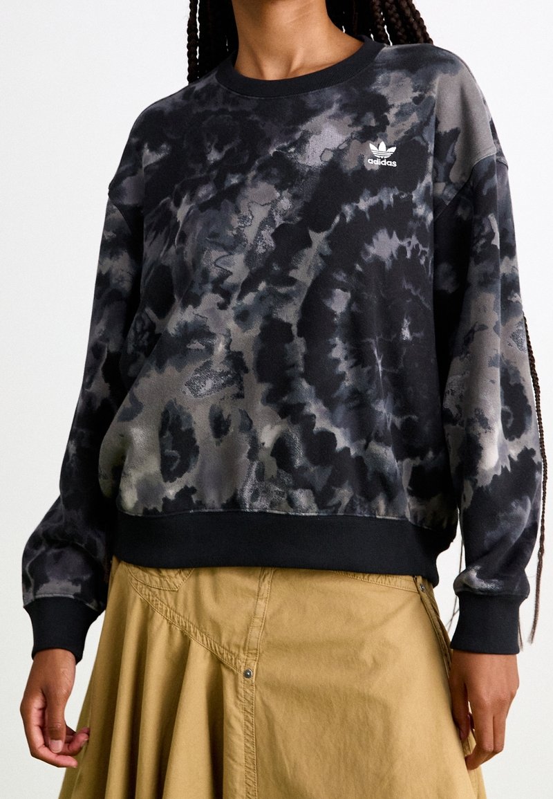 Black and gray tie-dye sweatshirt featuring a ribbed neckline and cuffs, with a small white Adidas logo on the chest.