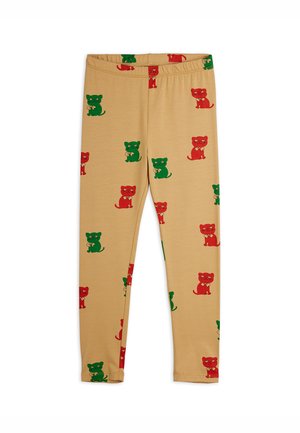 Leggings beiges à taille élastique avec un motif répétitif de chats rouges et verts tenant des pelotes de laine.