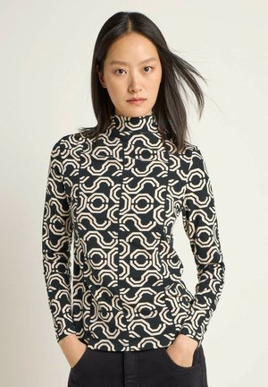 Langarm-Top mit hohem Kragen in Schwarz und Creme, das ein geometrisches Muster aus ineinandergreifenden Formen und einer glatten Stofftextur aufweist.