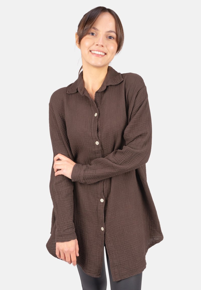 Brown, textured button-up shirt with a relaxed fit, long sleeves, and a collar. Features a slightly longer back and small buttons.