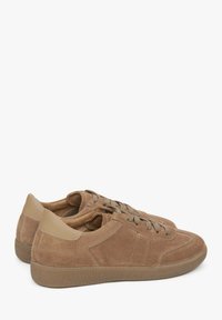 Brown suede sneakers with textured surface, lace-up closure, and beige leather accents on the heel and side. Rounded toe and rubber sole.
