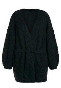 Cardigan a maglia a trecce di colore blu navy scuro. Presenta un profondo scollo a V, maniche lunghe a palloncino, vita con cintura e polsini a costine. Tessuto in misto lana testurizzato.