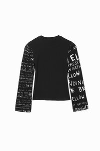 Black long-sleeve top featuring a solid back and patterned white text on one sleeve. Text includes phrases about nature and enlightenment.