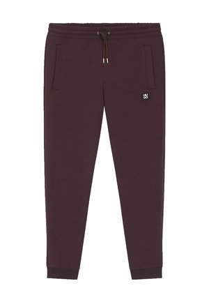 Bordeauxrote Jogginghose mit Kordelzug am Taillenbund, gerippten Bündchen, zwei seitlichen Taschen und einem kleinen schwarzen Logopatch am linken Oberschenkel.