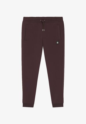 Burgundy sweatpants with a drawstring waist, ribbed cuffs, two side pockets, and a small black logo patch on the left thigh.