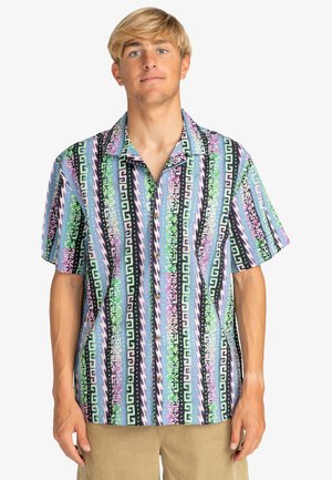Short-sleeve button-up shirt featuring multicolored geometric patterns in green, purple, black, and blue on a light background.