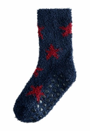 Marinblå, fluffiga strumpor med röda stjärnmönster, strukturerat material och gummidots på sulan för grepp. Ankellånga med en mjuk, varm utseende.