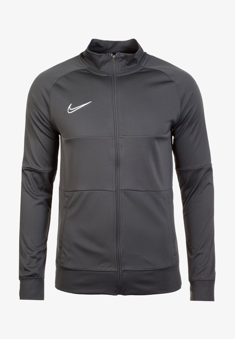 Veste de sport noire Nike zippée avec manches longues et col montant, arborant un logo Nike swoosh blanc sur la poitrine.