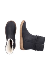 Black leather ankle boots with a soft lining, zipper closure on one side, and textured brown rubber sole. Slouchy design with stitching accents.