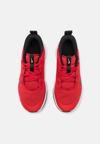 Rote Sportschuhe mit Netzobermaterial, schwarzen Akzenten und weißen Sohlen. Verfügt über flache Schnürsenkel und einen Zuggriff an der Ferse. Nike-Logo-Detail.