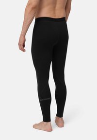 Musta lämpöleggingsit, joissa on muotoiltu malli, sileä rakenne ja logo painettuna alahäntä. Näkyvä joustava vyötärö.