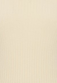 Top de punto acanalado beige claro con una textura suave y un diseño ajustado, que presenta líneas verticales que realzan su forma.