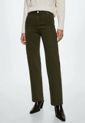 High-waisted dark olive straight-leg pants paired with dark brown heeled boots and a cream cable-knit sweater.