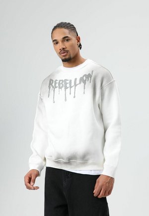 Witte sweatshirt met ‘REBELLION’ in druipende zilveren letters. Heeft een losse pasvorm, geribbelde manchetten en zoom. Soepele textuur.