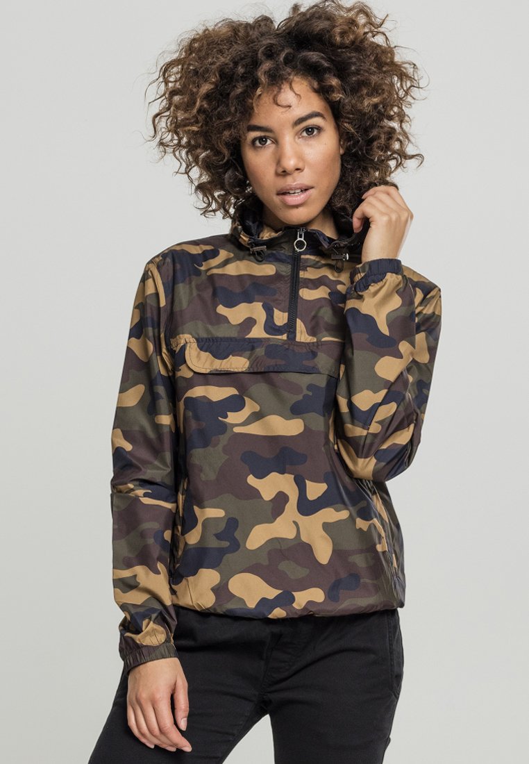 Camouflage pullover jacket with zip collar, elastic cuffs, and a pocket; features brown, green, and black patterns on a shiny fabric.