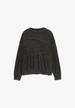 Pull vert foncé avec un design de logo texturé sur le devant, encolure côtelée et coupe légèrement oversize. Matière douce et tissée.