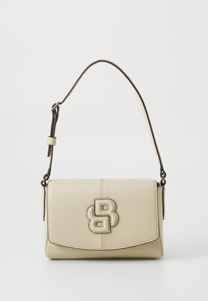 Cream-colored leather handbag with a structured design, featuring a prominent embossed logo, a flap closure, and an adjustable strap.