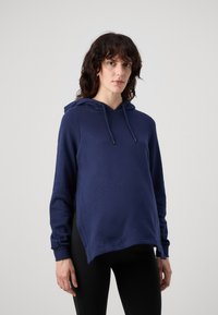 Sudadera azul marino con cordón, aberturas laterales y mangas acampanadas, confeccionada en un material suave y con un diseño de corte relajado.
