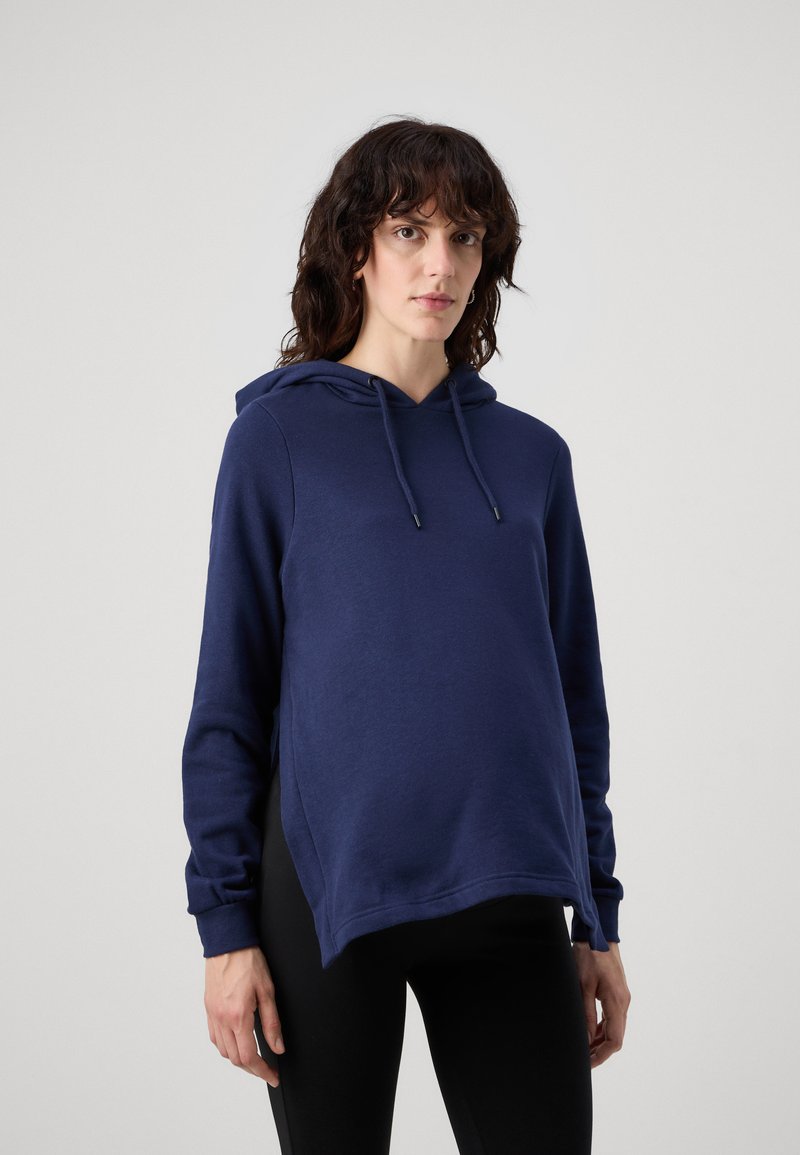 Sudadera azul marino con cordón, aberturas laterales y mangas acampanadas, confeccionada en un material suave y con un diseño de corte relajado.